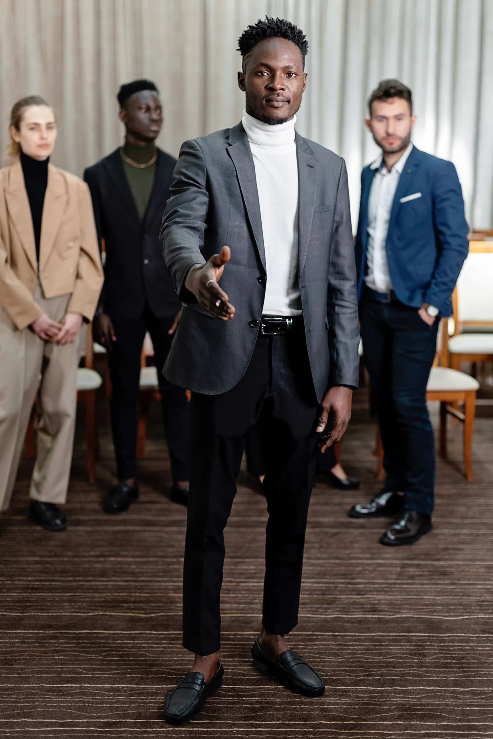 A man offering a welcoming handshake.