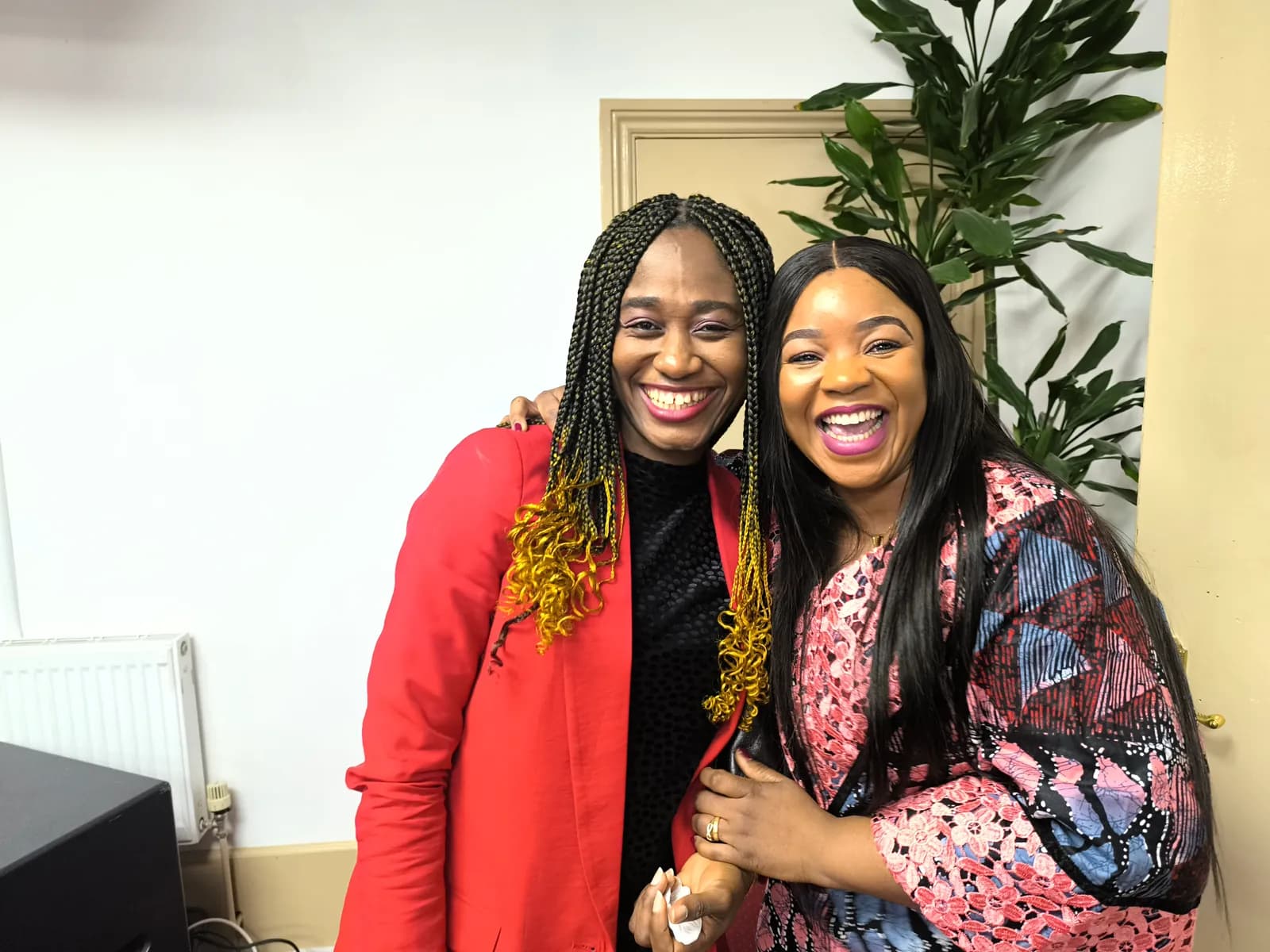 Two women sharing a joyful moment of fellowship.